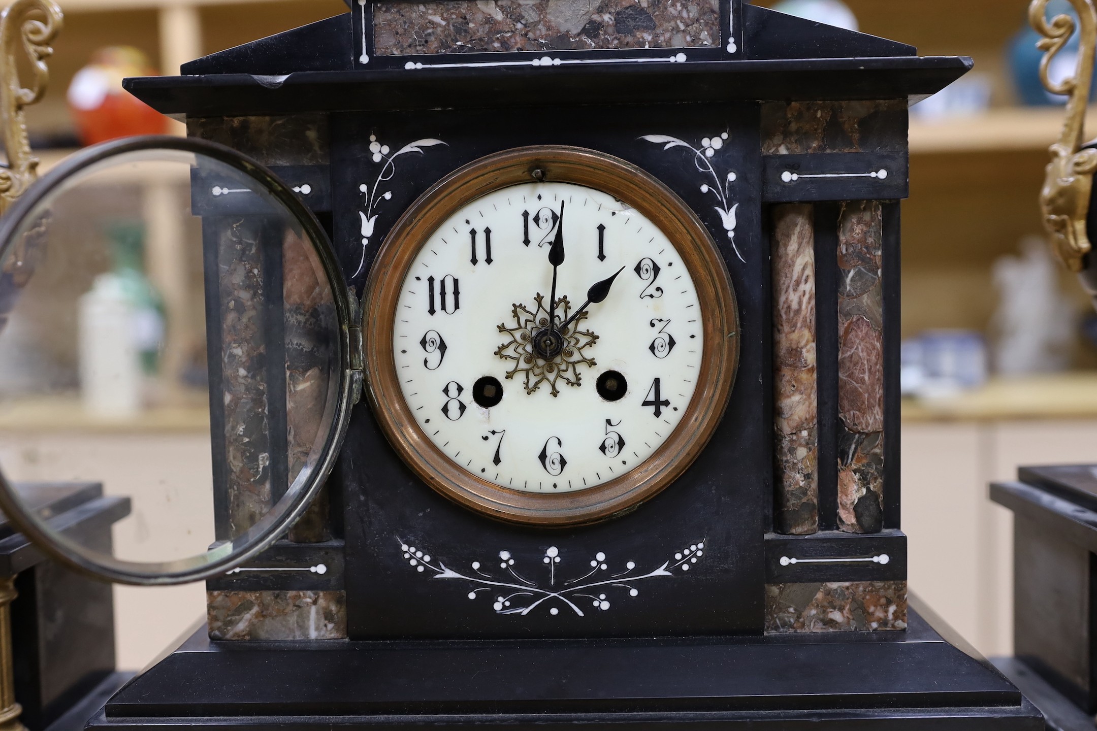 A black slate and marble clock garniture, c. 1890, clock 33cms high